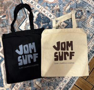 Black & Beige Jomsurf canvas tote bags with surf-inspired logo design 